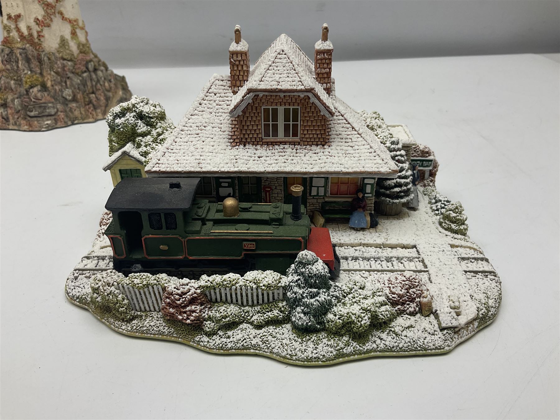 Five Lilliput Lanes, comprising Christmas at Woody Bay Station and Calling Home for Christmas both from the Illuminated collection, Castle of the Exiled Prince, Castle of The Ransomed King and Helvellyn, all with original boxes (5)