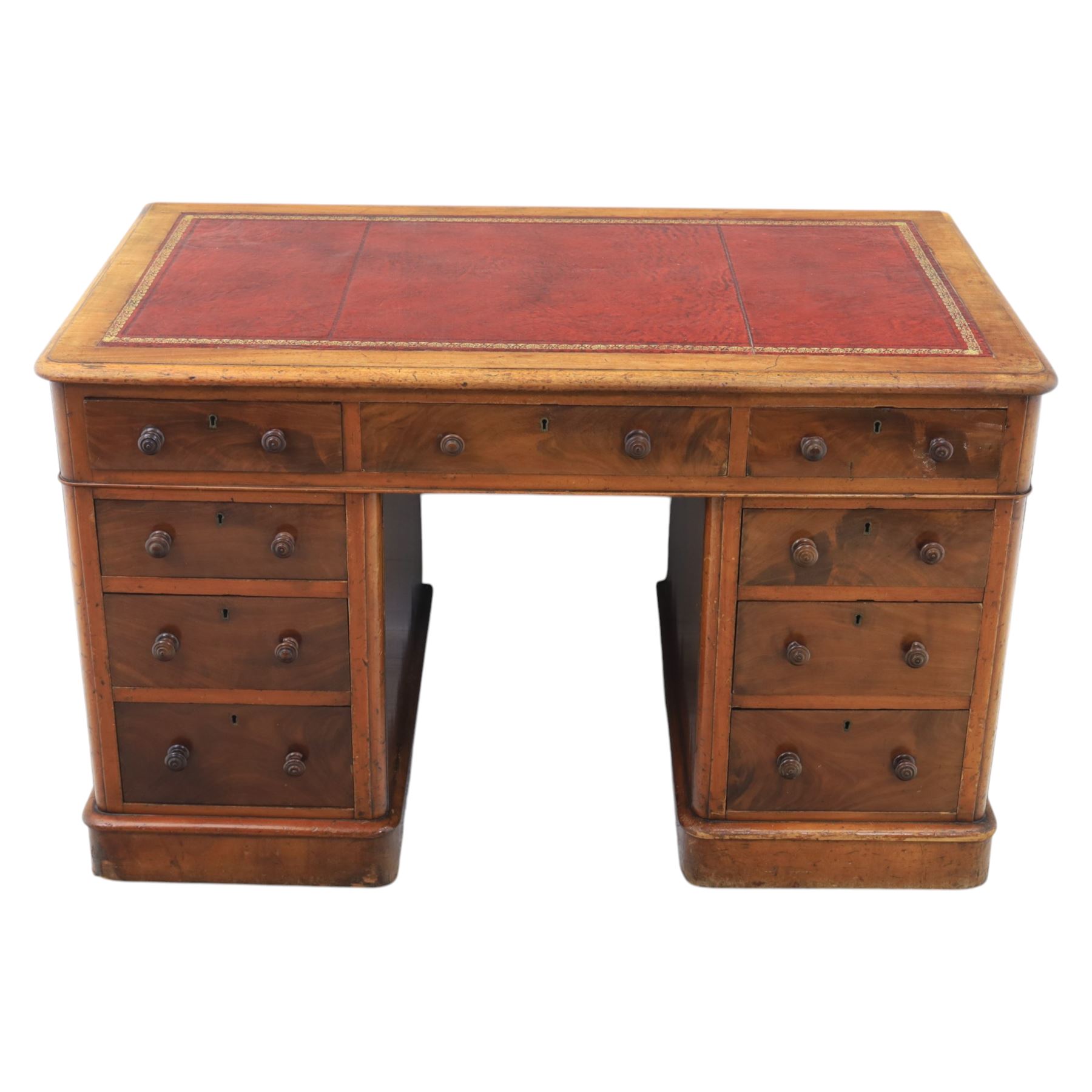 Victorian mahogany writing desk, featuring inset tooled red leather top, raised on two pedestals, nine drawers with figured veneer fronts