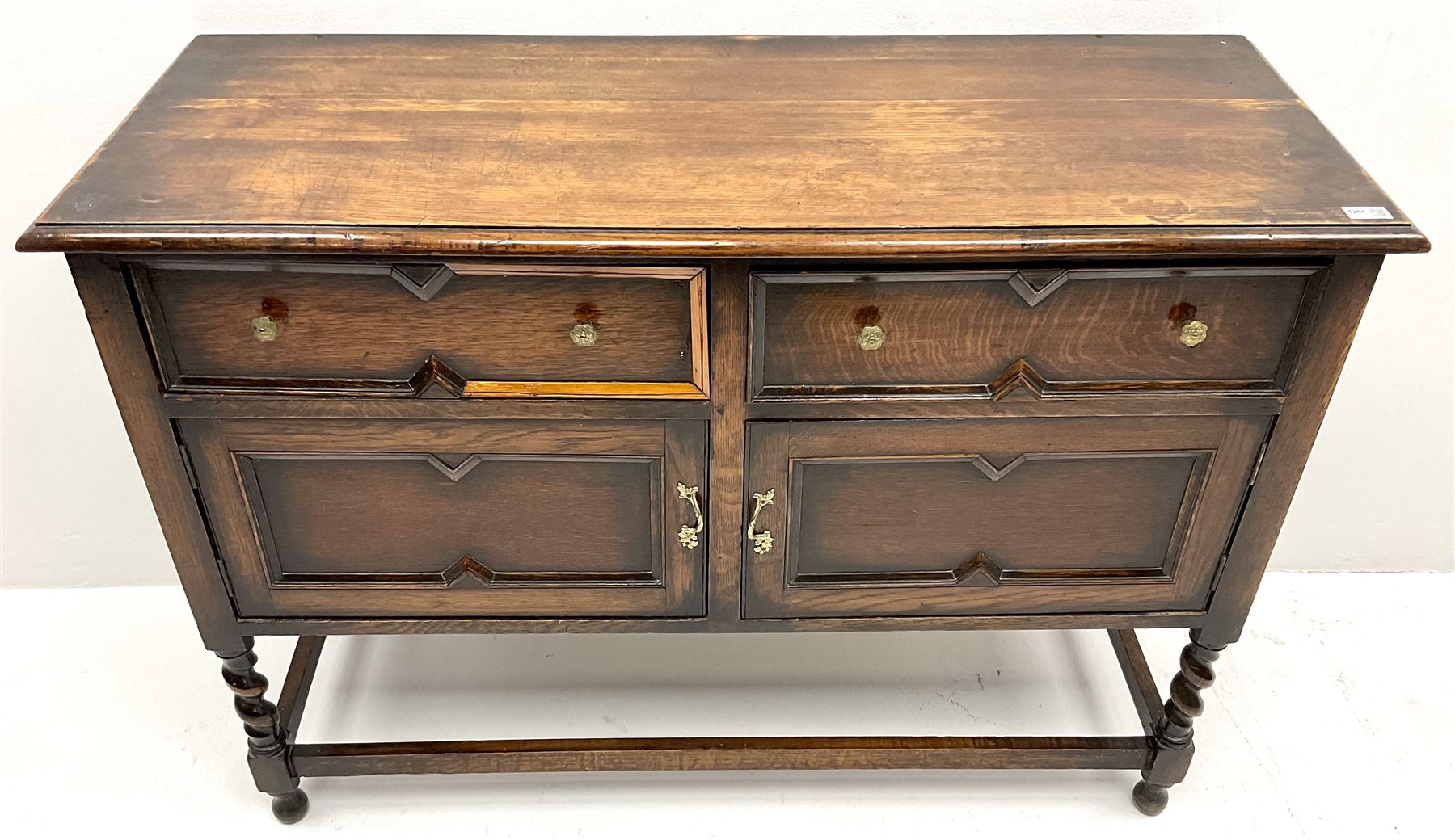  Jacobean style oak sideboard, two drawers above two cupboards, barley twist supports joined by stretchers 