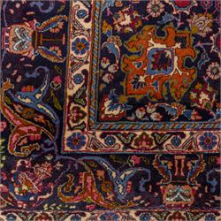 Persian Kashan wool carpet, red field centred with large floral medallion and conforming pendants, decorated with scrolling foliage and flowerheads, indigo spandrels and borders, from the region of Kashan