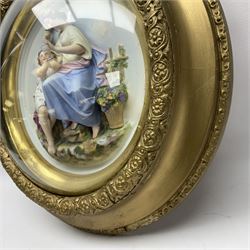 Set of four early 20th century Continental bisque plaques, each of circular form, modelled in high relief as the Four Seasons personified, within gilded circular frames under convex glass, overall D44.5cm