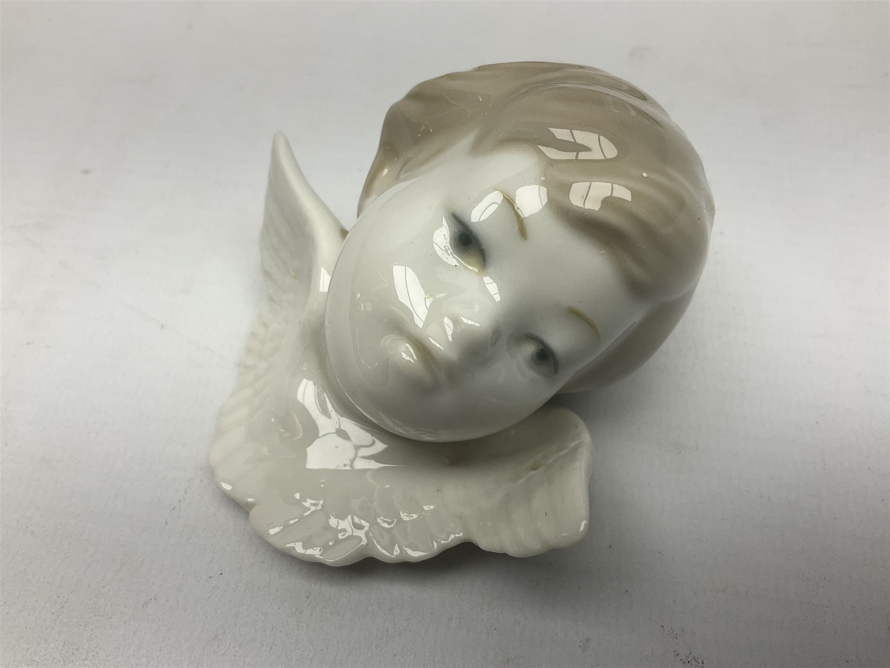 Three Lladro figures, comprising Dear Santa no 6166, Angelic Melody 1993 no 5963 and Seraphs Head no2 no 4885, together with Lladro plaque Love Brings Us Together no 7677, all with original boxes, largest example H18cm