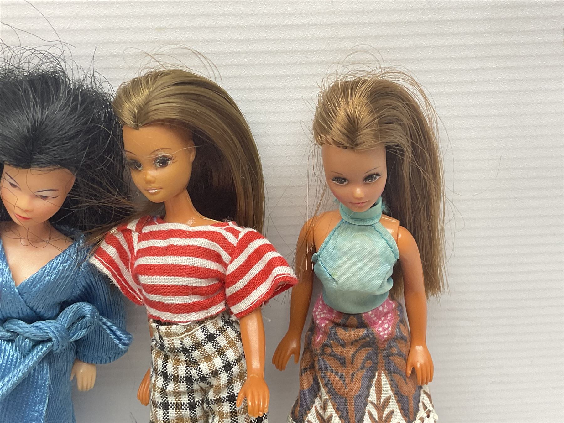 Seven Pippa dolls and a collection of plastic dolls house furniture