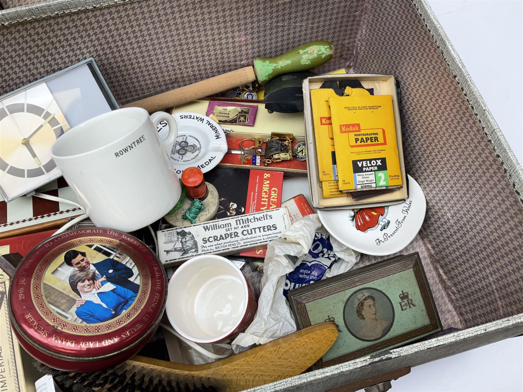 Ukelele, Westclox electric alarm  clock, vintage tins, National Rail hat, ceramics, boxed games, carved wood figures etc all housed in a suitcase