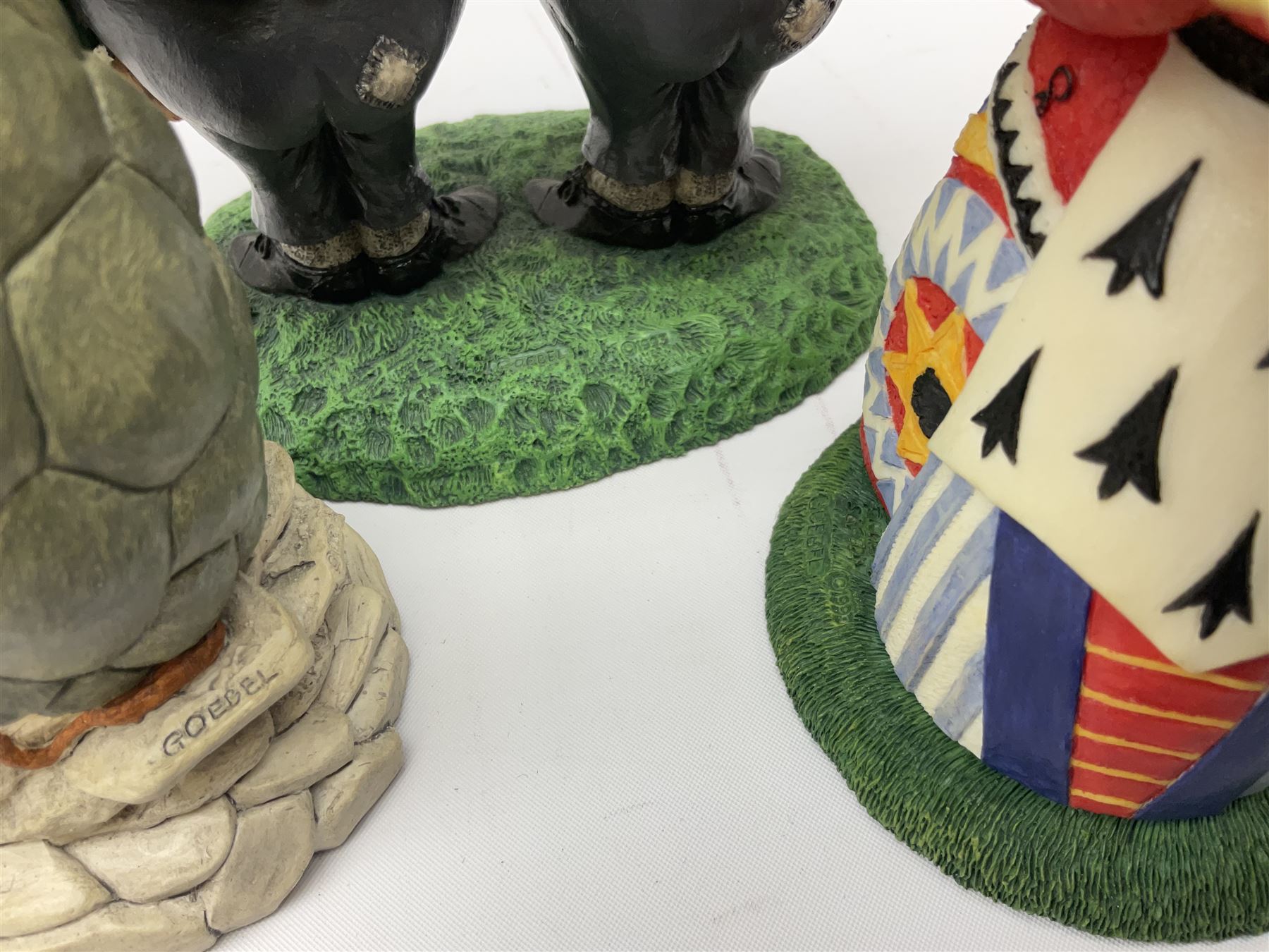 Goebel Alice in Wonderland figures, comprising Alice and Cat, White Rabbit, Queen of Hearts, March Hare, Tweedle Dee and the Mock Turtle, largest H18cm