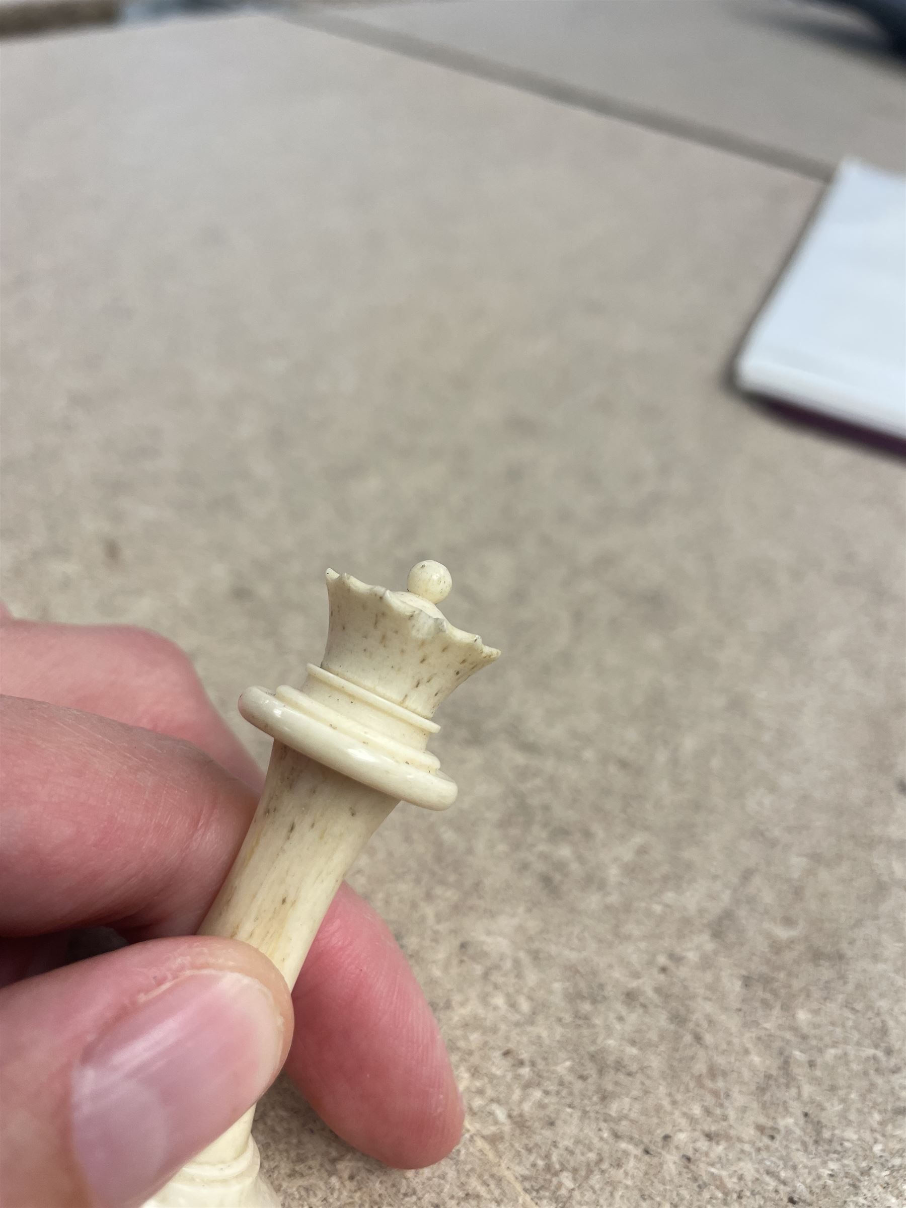 19th century walnut and brass bound games compendium box, painted to enhance the grain, of rectangular form, the hinged opening cover with rounded sides, central brass cartouche with engraved lion crest, and brass riveted straps, opening to reveal a red leather and blue silk lined compartmented interior, with fold-down games board, and lift-out tray containing playing cards, ebony turned dice towers, white and red stained bone draughts, and chess pieces, ivory dice, and ivory and ebony whist markers, and brass bezique board, cribbage board and markers, H15cm W32cm D24cm
This lot has been registered for sale under Section 10 of the APHA Ivory Act