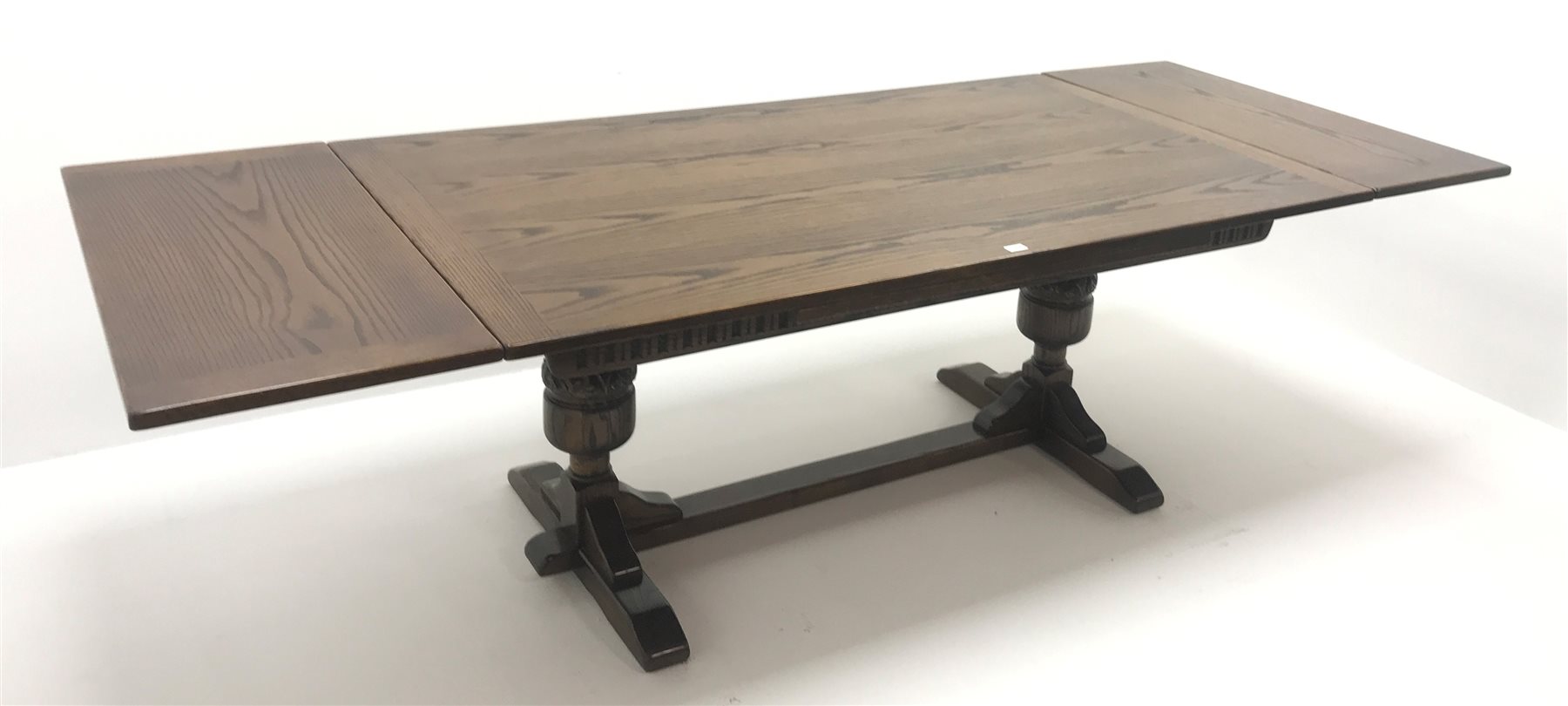  Old Charm oak drawer leaf dining table, carved cup and cover supports on shaped sledge feet joined by single stretcher (W275cm extended, 183cm closed, H76cm, D108cm) and set eight (6+2)  chairs, arched cresting rail with finials, studded leather back and seat, cup and cover supports joined by stretchers (W  