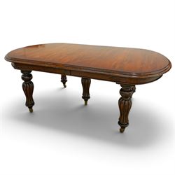 Large Victorian Country House mahogany extending dining table, the oval top with moulded edge over a plain frieze, raised on five large turned and reeded supports, with winding extending mechanism and additional leaf