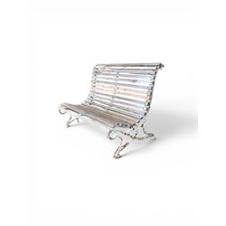 19th century cast iron and wood slatted garden bench, high scroll back form, low X shaped base, finished in distressed white paint