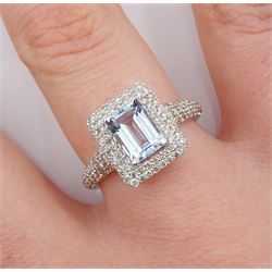 18ct white gold emerald cut aquamarine and diamond cluster ring, with diamond set shoulders, stamped K18, aquamarine 0.85 carat, total diamond weight 0.62 carat