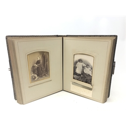  Victorian photograph album, leather bound with gilt initials and edges and brass clasp, partially stocked with cabinet portraits to the floral chromolithograph leaves  