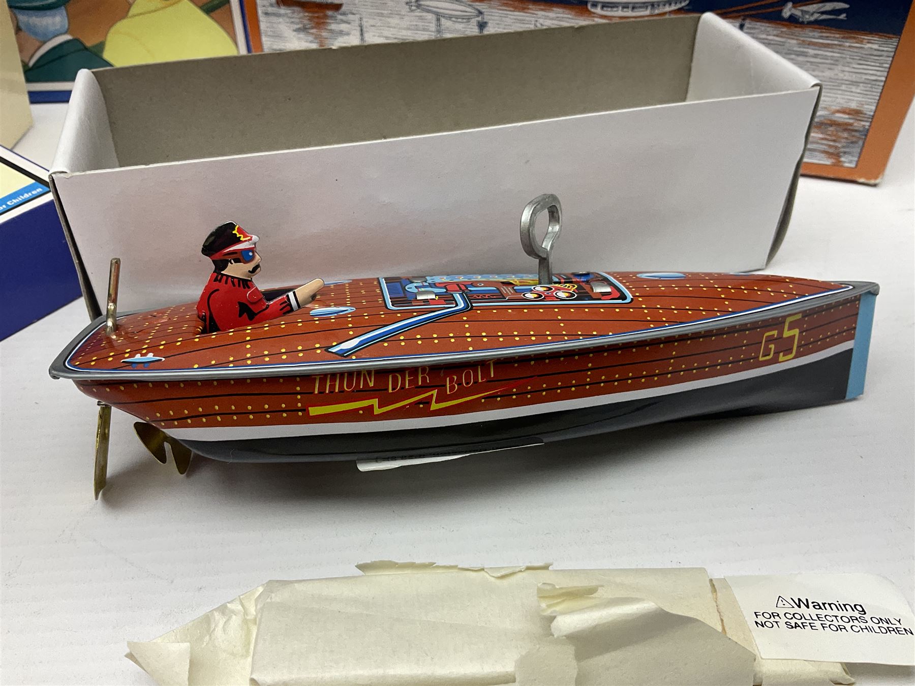 Schylling - six tinplate models comprising Sir Ian’s Bluebird racing car, Speedway Auto Racer, two Aluminium Airships, Tin Speedboat and Ernest in the Music Box; all in original boxes 