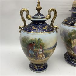 19th century Vienna style porcelain 'Musik' garniture, the central vase of baluster form with domed cover flanked by two smaller vases with twin curved gilt handles to short neck, each decorated with classical figural vignettes between blue borders heightened with gilt, H33.5cm