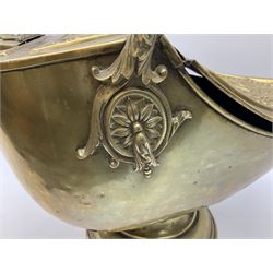 Victorian brass helmet shaped coal scuttle with embossed decoration and turned wooden handle and shovel, H49cm