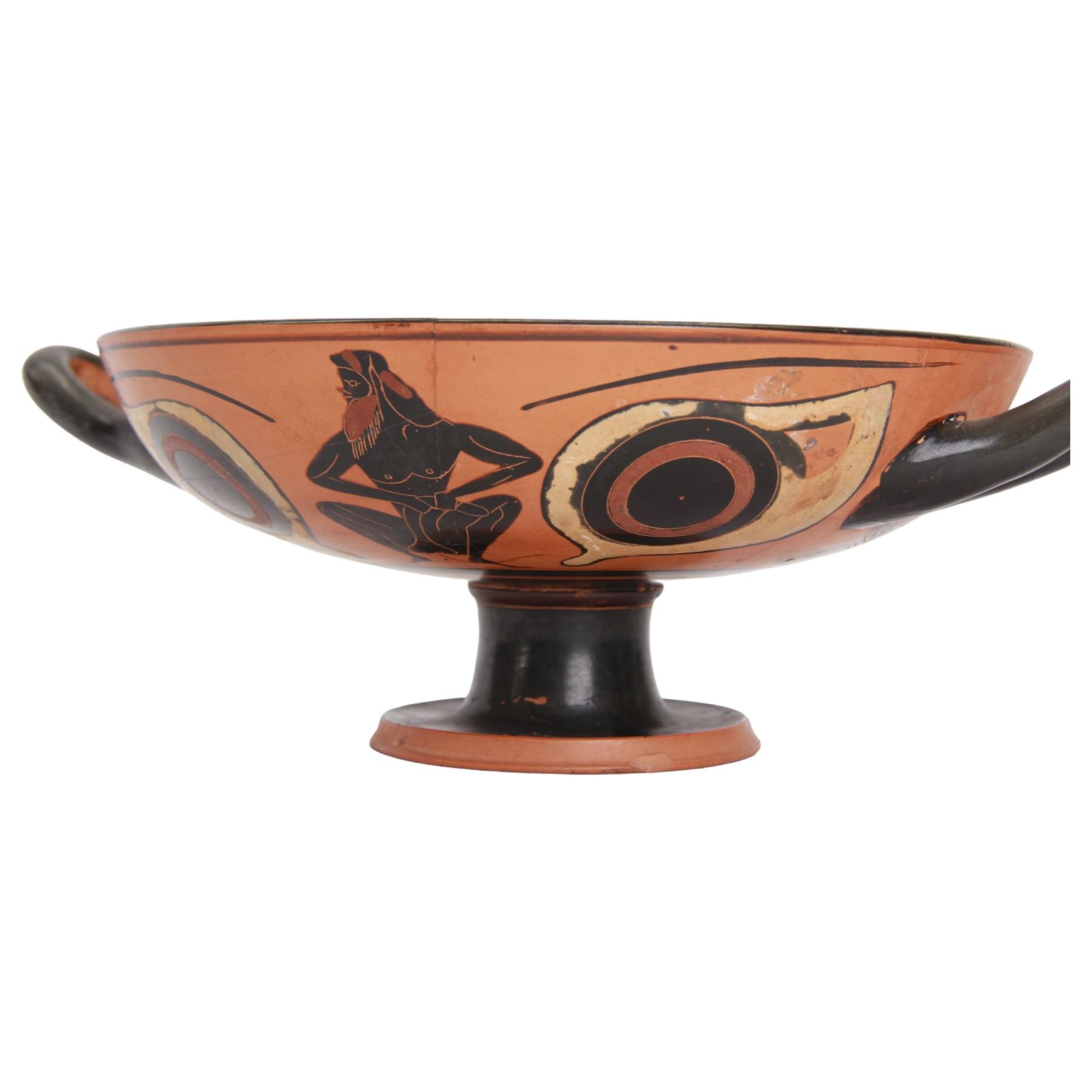 Greek Attic Black-figured eye cup, of typical form with twin handles, the exterior painted with erotic figures flanked by apotropaic eyes, the black interior with reserved tondo with ring dot motif, upon pedestal foot, including handles H9.5cm W28.5cm cup D21.5cm
