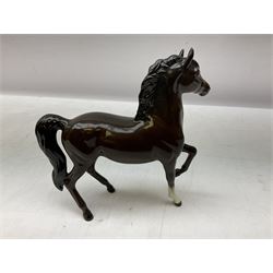 Five Beswick horse figures, comprising bay Hackney pony no. H261, bay stocky jogging mare no.1090, bay horse no.1549, and two Prancing Arabs in bay and palomino no. 1261, all with printed mark beneath 