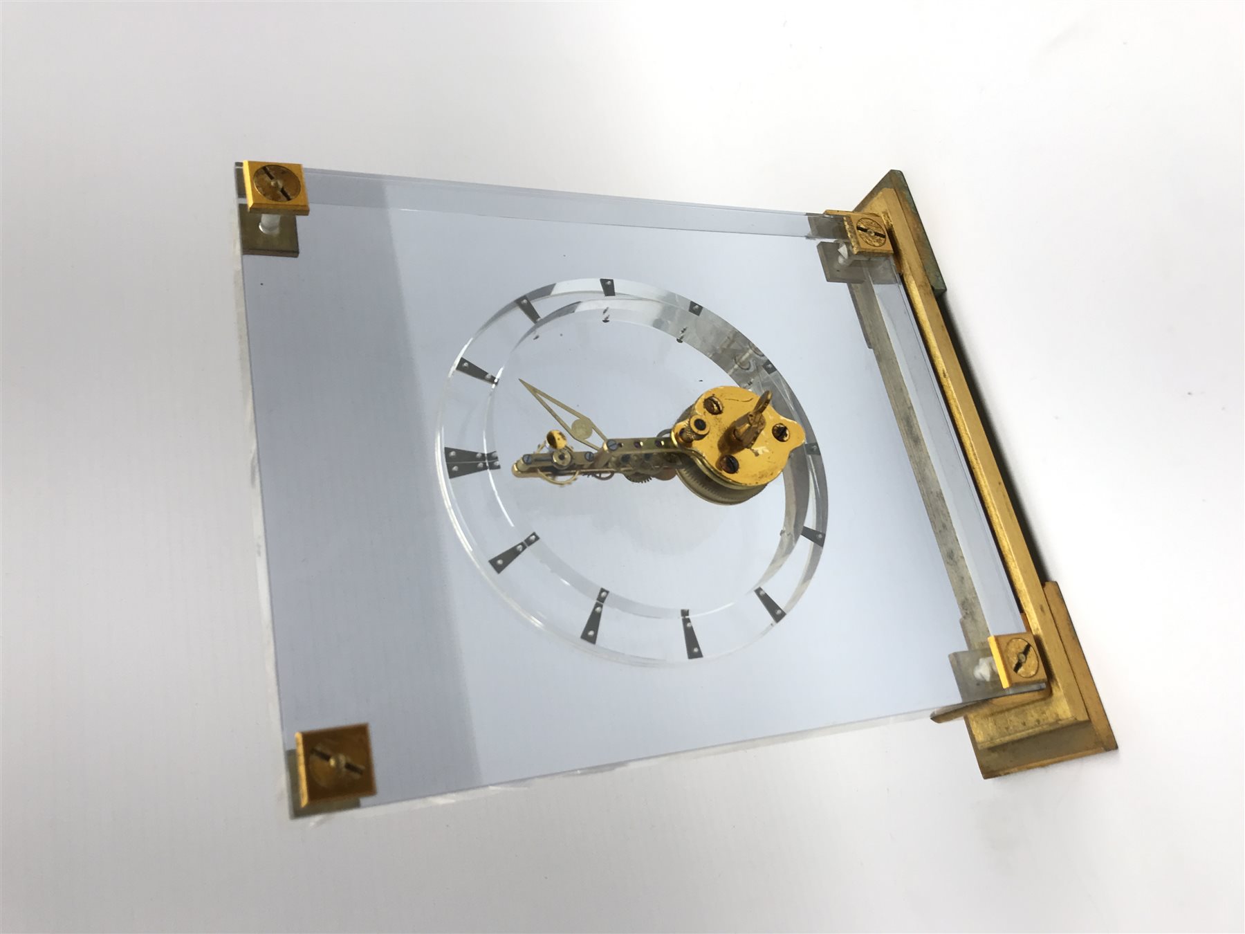 Mid 20th century Jaeger-LeCoultre skeleton clock, gilt metal mounts and stepped base, W18cm, H20cm
