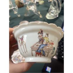 Set of Chinese 20th century tea wares, comprising three bowls of graduating sizes, teacup, spoon rest and small plate, decorated with scenes of figures around a table, each with scalloped rim, largest bowl D12cm