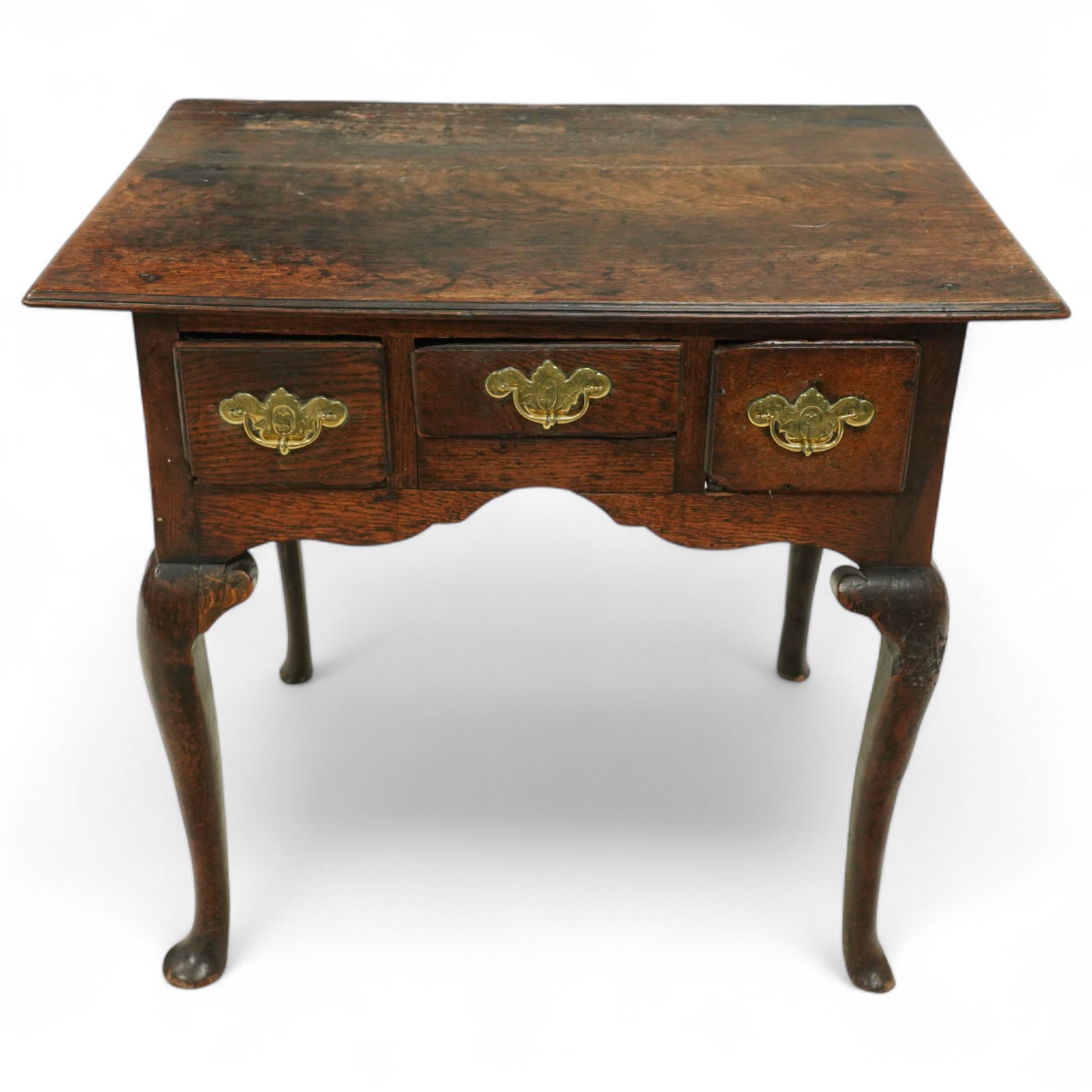 18th century oak lowboy, the three frieze drawers fitted with later brass handles, over shaped apron and cabriole legs with pad feet