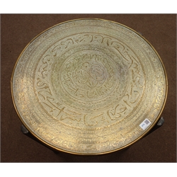  20th century Eastern Benares table on folding wooden base, circular brass top with embossed decoration   