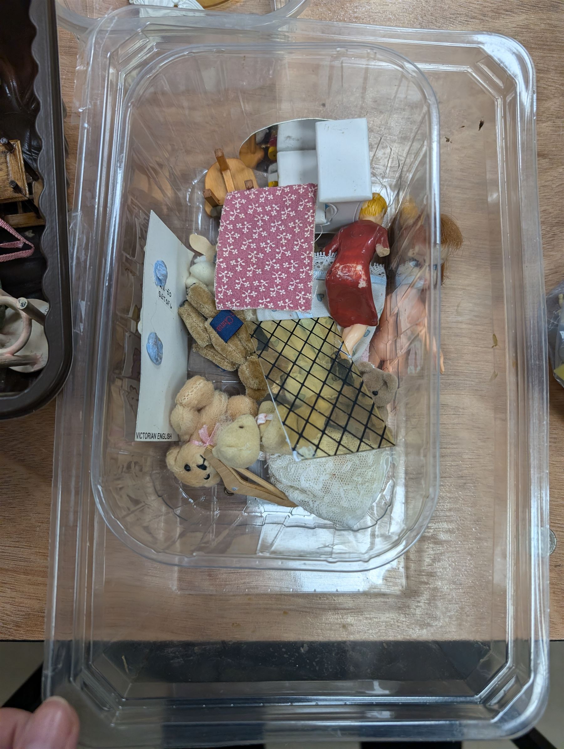 Two modern three storey dolls houses, each painted green with decorated interiors, both upon a single white wooden base, together with a large collection of dolls house furniture, accessories and figures 