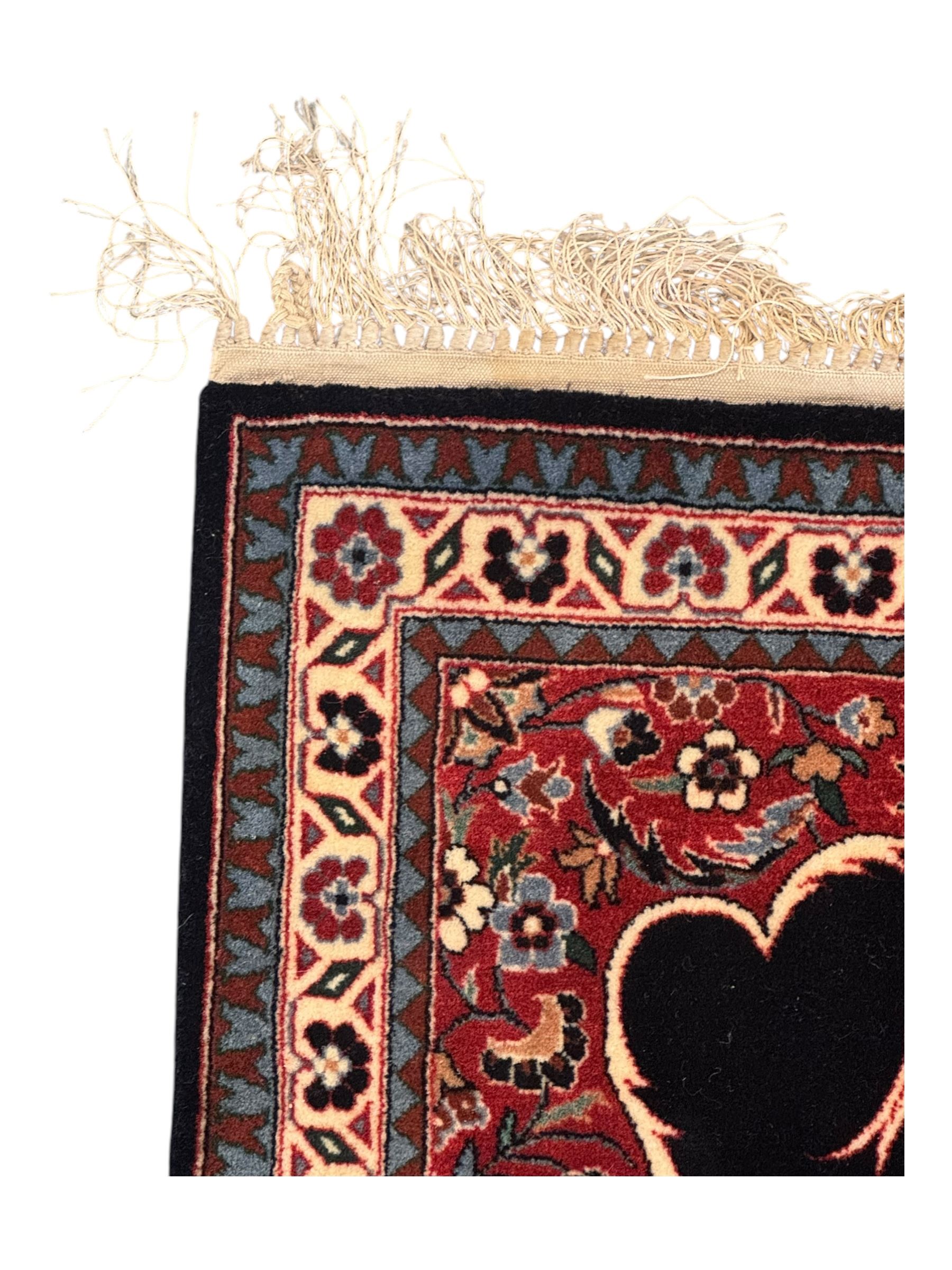 Persian-style wool rug, cream field with floral and geometric motifs, wide floral border (74cm x 142cm); Persian wool rug, beige field with dense floral patterns, narrow floral border (70cm x 144cm); Tribal wool rug, red and navy with diamond motifs (96cm x 60cm); Persian pictorial wool rug, black field with vase, birds, and floral border (70cm x 73cm)