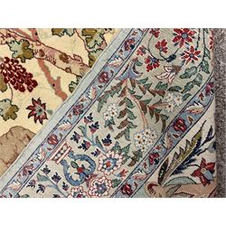 Fine Persian tree of life rug wall hanging, ivory ground field depicting landscape filled with animals, birds and flowers, the guarded border with stylised flower heads and foliage decoration, with brass hanging rail