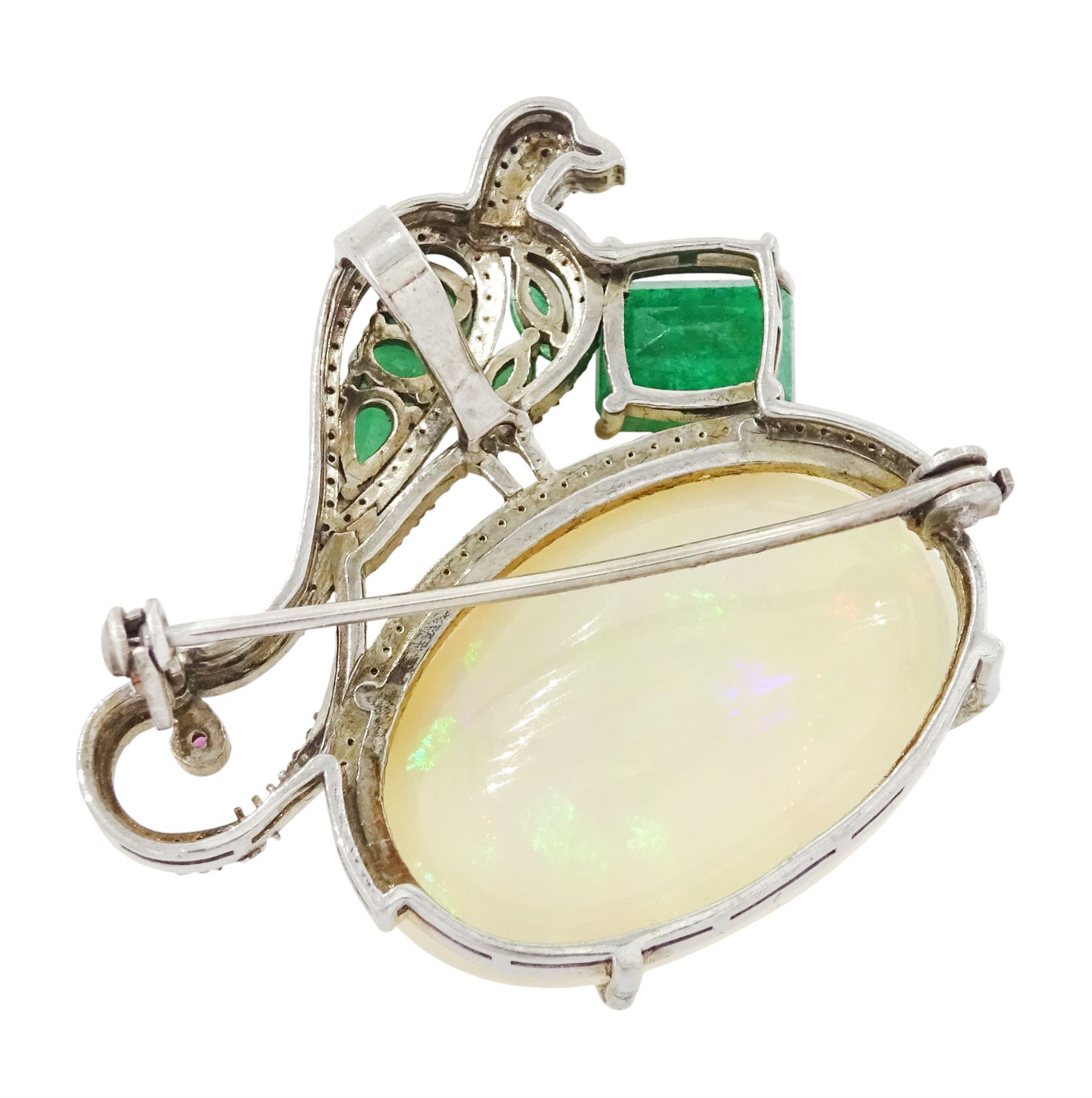 Silver opal, emerald, diamond and ruby bird pendant / brooch, emerald and diamond perched bird, on a single cabochon oval cut opal of approx 26.20 carat, total emerald weight approx 3.15 carat, total diamond weight approx 0.70 carat
