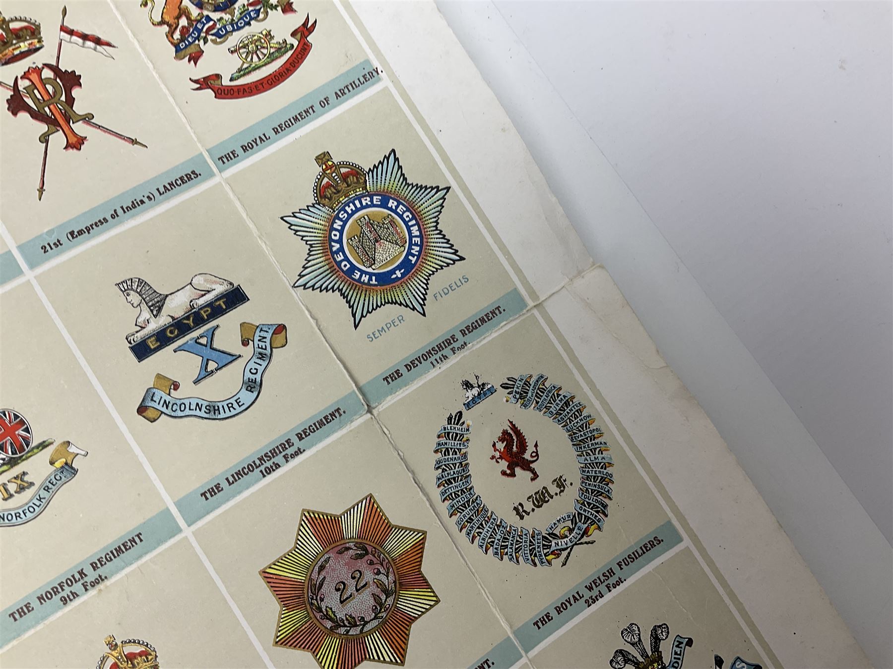 Large poster entitled 'Crests and Badges of the British Army in Daily Use 56 x 86cm; together with twenty-five colour prints of military interest including Crimean War, Boer War, WW2 etc; various sizes; all unframed