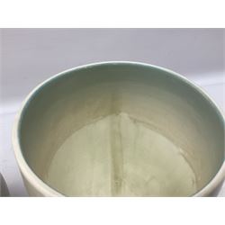 1930s Carlton Ware Art Deco Garden pattern vase of shouldered ovoid form, decorated with blue, pink and yellow flower heads on a mottled blue and white ground, pattern no. 3413, with printed and painted marks beneath, H19cm, together with a Clarice Cliff My Garden pattern vase, raised upon three feet with blue, pink and purple moulded Hollyhock design, H20cm, with Clarice Cliff Wilkinson Ltd England marks beneath