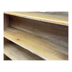 Contemporary French provincial design oak open bookcase, with projecting moulded cornice above a boarded back, fitted with four adjustable shelves, on bracketed plinth base