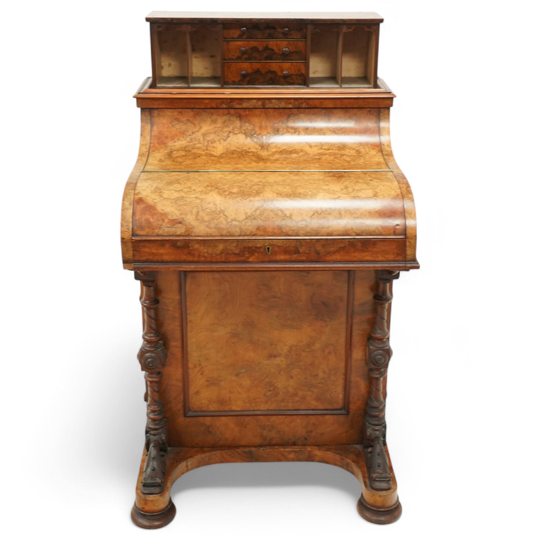 Victorian figured walnut piano top Davenport desk, hidden compartment lifting to reveal small drawers and pigeonholes, the piano lid enclosing drawers and sliding top with hinged leather writing surface, the right-hand side fitted with four drawers, on compressed bun feet 