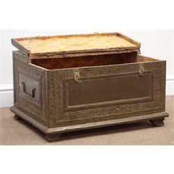  Middle Eastern brass covered hardwood box with hinged half lid, decorated in relief with scrolled leafage and foliage, angular carry handles and bracket feet, W61cm, H35cm, D45cm  
