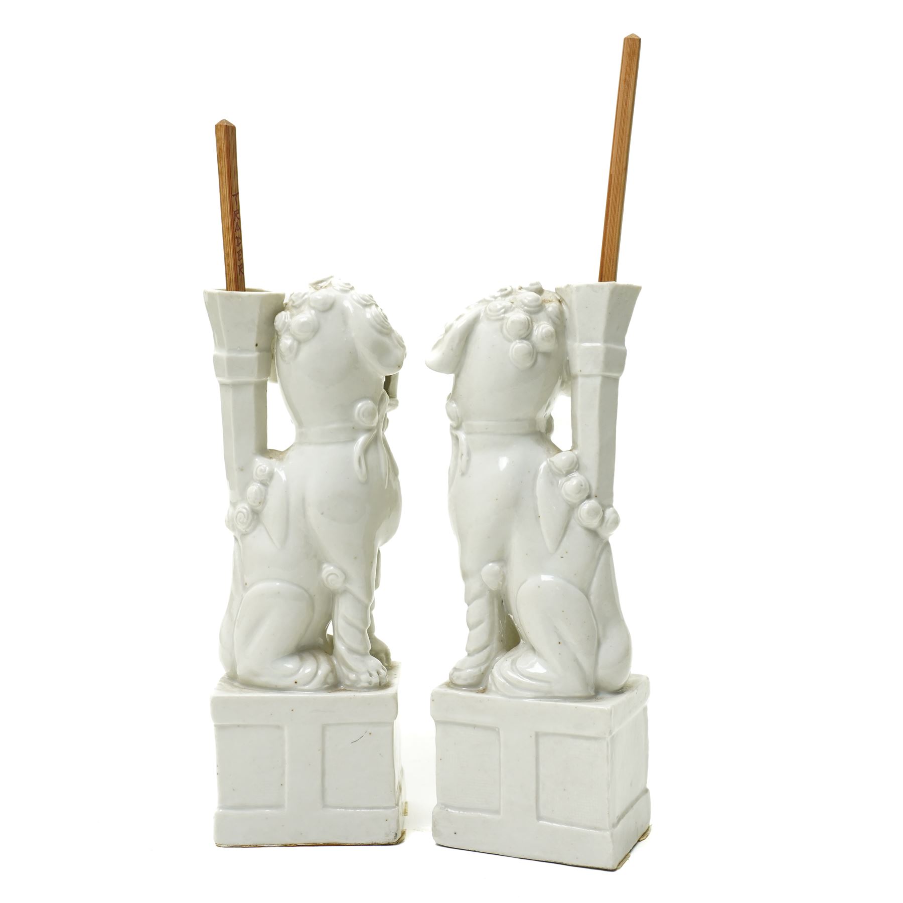 Pair of 19th century Chinese blanc de chine joss stick holders in the form of  Buddhist lions on rectangular bases H20cm (2)