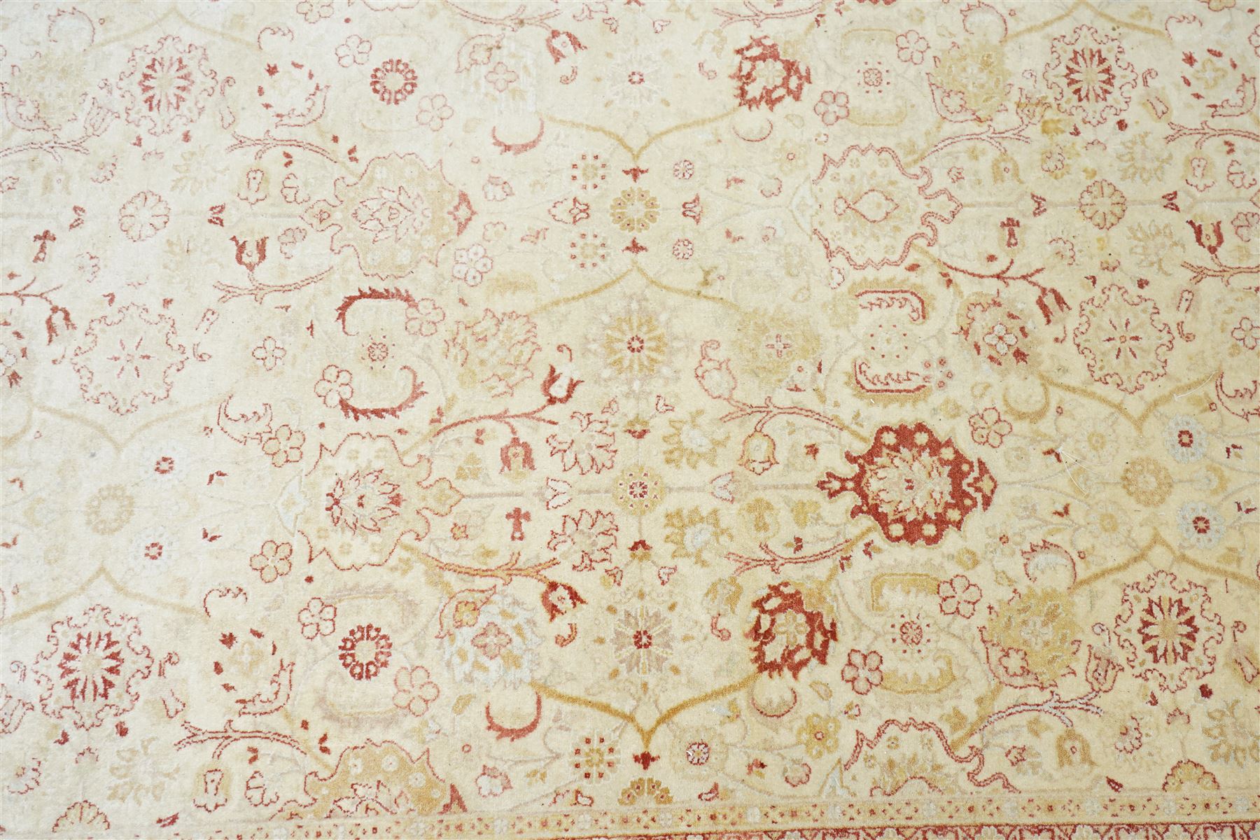 Modern Pakistani Oushak style wool hand-knotted carpet,  ivory field with an all-over scrolling floral vine design in soft tones of madder red and pale gold, enclosed by a conforming border, with cotton fringe ends  