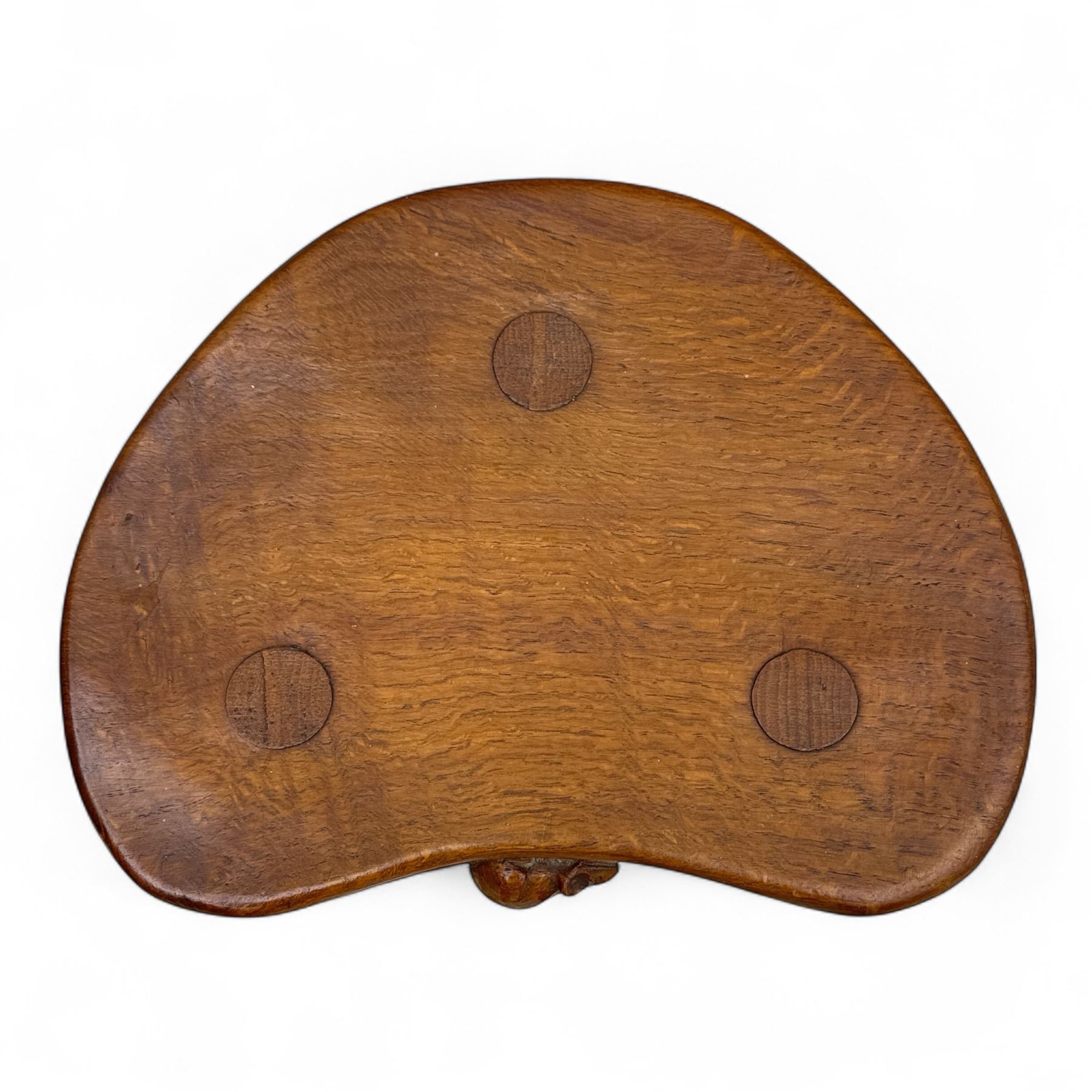 Mouseman - oak three-legged calf stool, kidney-shaped seat carved with the signature mouse motif, by the workshop of Robert Thompson, Kilburn