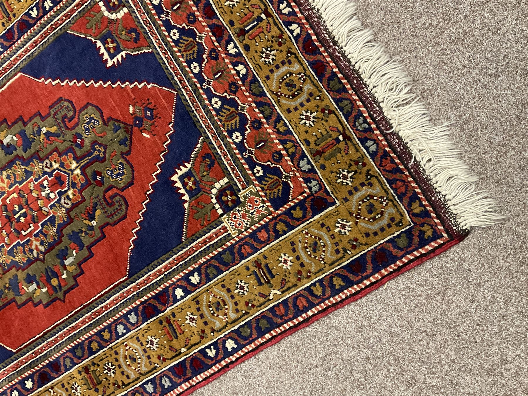 Turkish Taspinar rug, blue ground with central lozenge and medallion, the outer borders decorated with stylised motifs