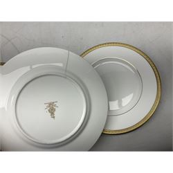 Royal Doulton Royal Gold pattern tea and dinner service for eight, comprising dinner plates, side plates, tea plates, soup bowls, sauce boat and saucer, dessert bowls, coffee cans and saucers, teacups and saucers and two lidded tureens