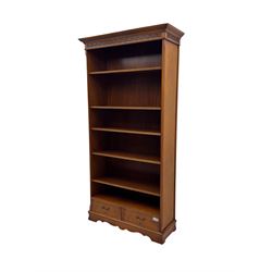 Ian Smith Furniture - Georgian design walnut open bookcase, projecting cornice over pierced geometric frieze, fitted with three adjustable fluted shelves above two drawers, on shaped plinth base 