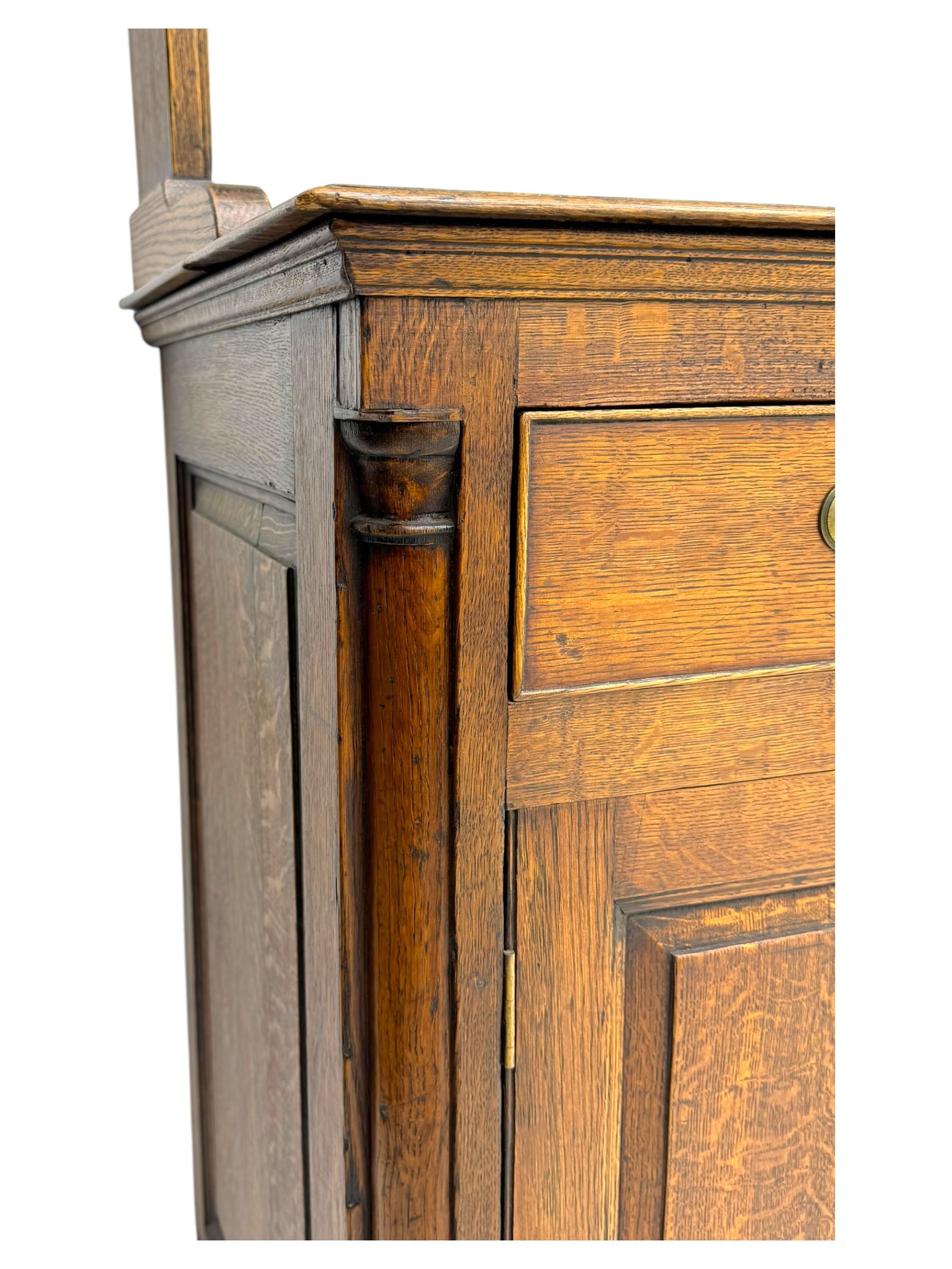 19th century and later oak dresser, moulding cornice a pierced and shaped frieze, over two open plate shelves above a base fitted with two drawers with brass swan neck handles, over panelled twin cupboard with single shelf, cantered corners on bracket feet
