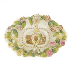 Early 19th century Rockingham porcelain basket, circa 1830, of elongated octagonal shape with gilt entwined, encrusted handle, the centre painted with a view of 'New Cemetery Liverpool', the rim encrusted and moulded with flowers and leaves, with puce Griffin mark and titled beneath, including handle H10.5cm W23cm