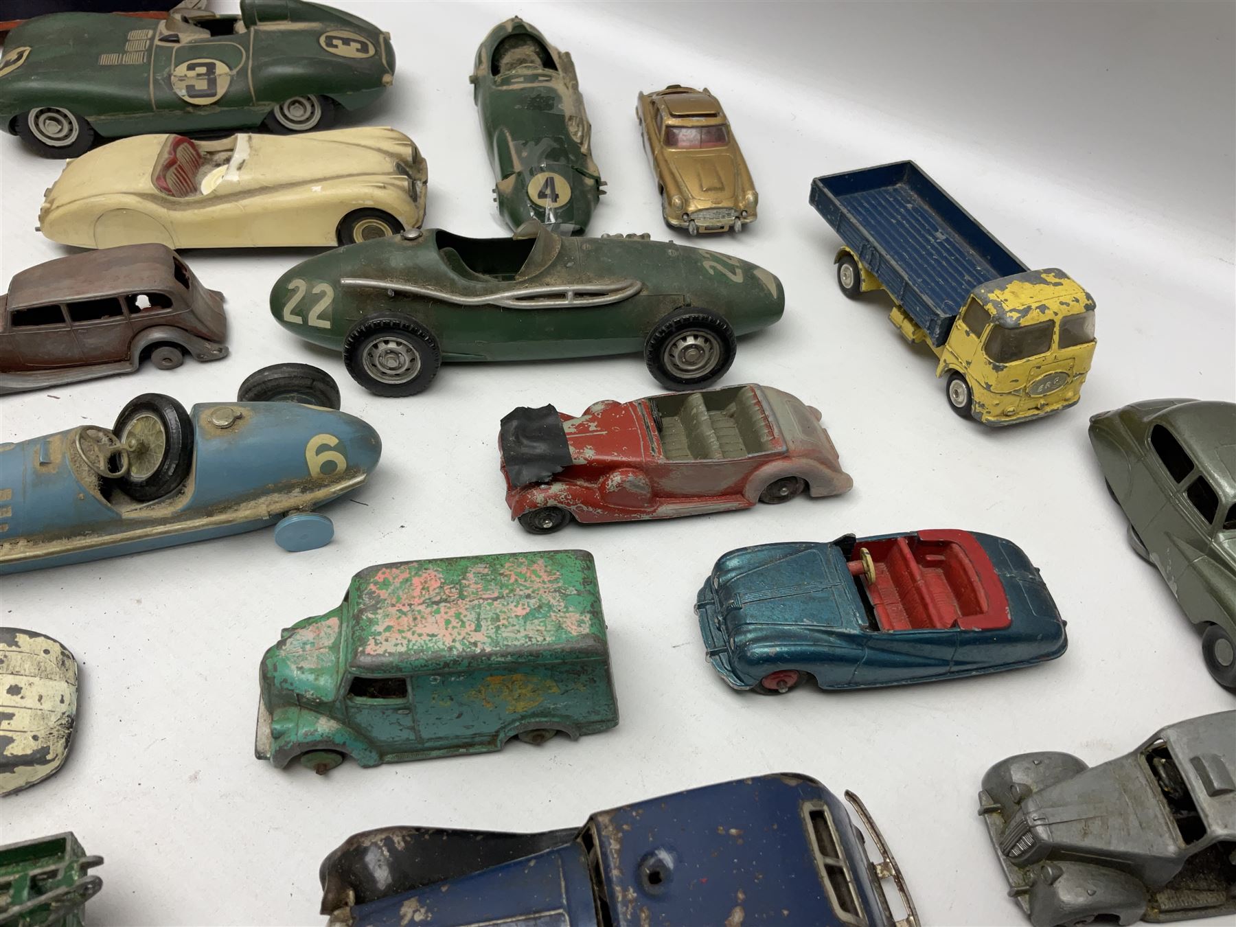 Various Makers - fourteen unboxed and playworn die-cast models including Wee-Kin Sunbeam Talbot, Corgi James Bond Aston Martin and ERF lorry, Dinky Thunderbolt Racing Car, Cadillac Eldorado, Cunningham C5-R, Lagonda etc; Minic tin-plate police car and jeep; other tin-plate models; Merit Plastic racing cars and quantity of spare parts etc