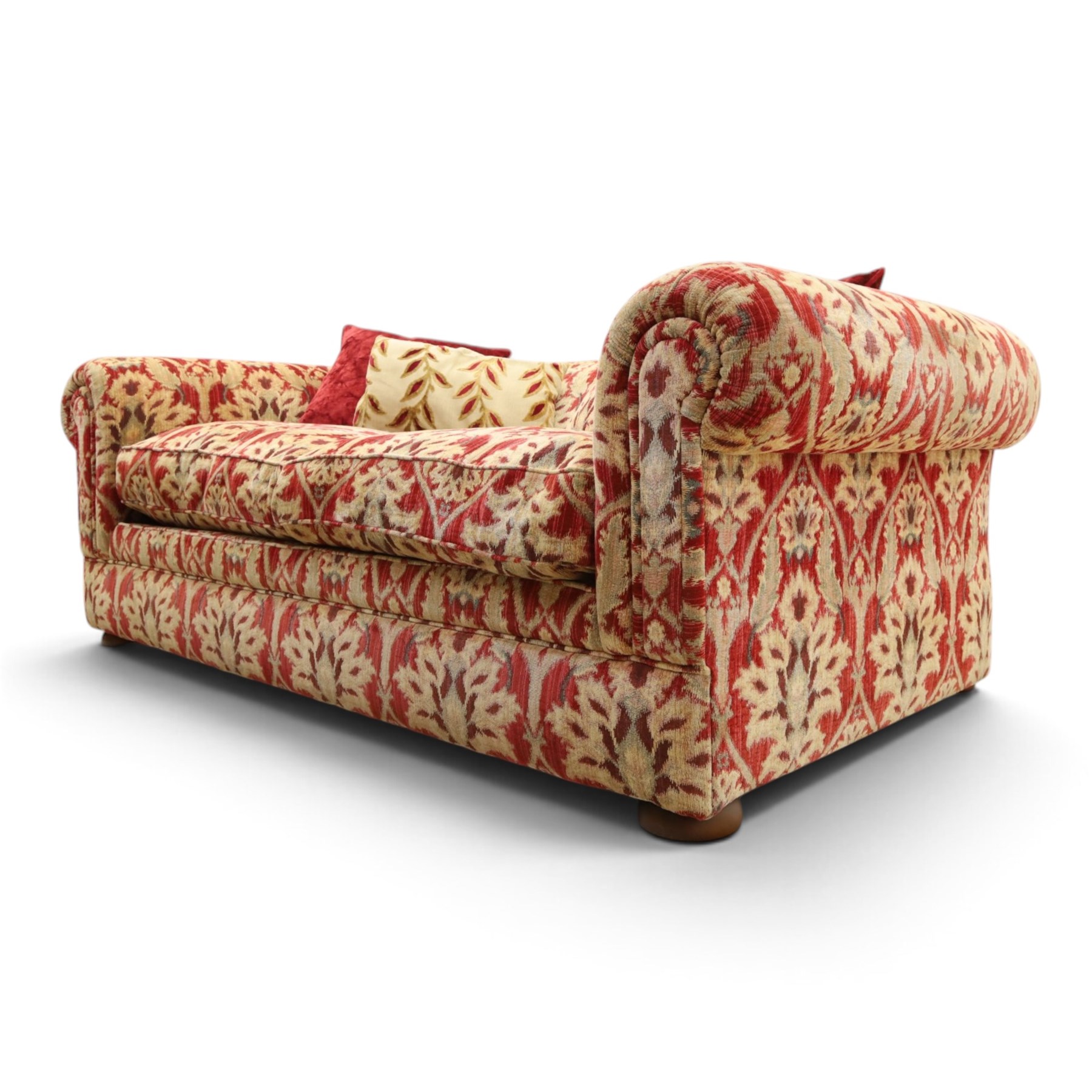 Tetrad - grande two seat 'Elgar' sofa of traditional Chesterfield shape with rolled arms, upholstered in red and gold foliate patterned fabric with matching loose and scatter cushions, on compressed bun feet