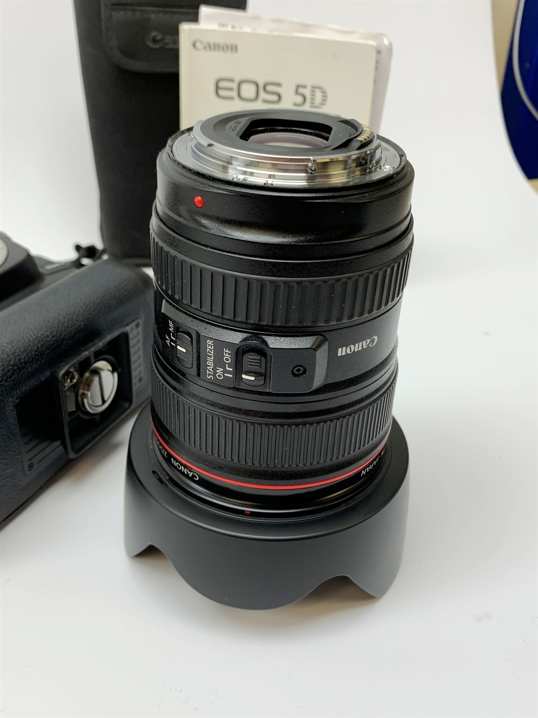 Canon EOS 5D camera body with Canon 'BG-E6' battery grip, Canon 'Speedlite 580EXII' flash and Canon lens 'Canon Zoom Lens EF 24-105mm 1:4 L IS USM' with Canon EOS 5D Mark II instruction manual