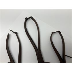 Three pairs of Georgian wrought iron spring loaded sugar nips each terminating in curved blades, one missing the spring, H22cm