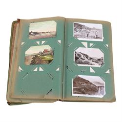 Collection of postcards in a album, together with an album of first day covers 