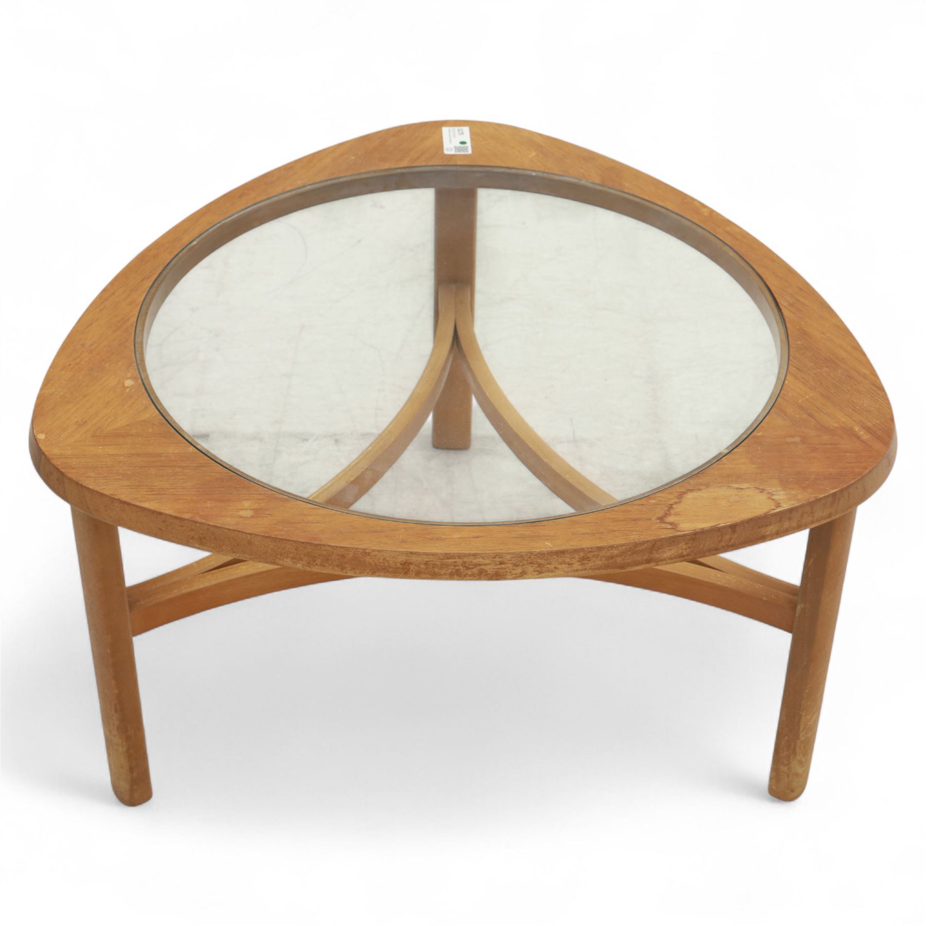 Mid-20th century teak and glass coffee table, of triangular form with rounded corners, inset circular glass top over curved stretcher base