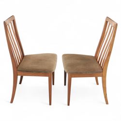 G Plan - mid-20th century teak extending dining table, oval top with integrated extension leaf, raised on tapering legs, together with a set of six slat back dining chairs including two carvers, upholstered in dark green velour (Extends to 210cm)