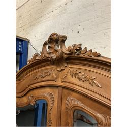 French walnut armoire wardrobe, carved feature above projecting cornice, two mirrored doors revealing shelving and hanging rail, plinth support