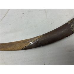 Late 19th/early 20th century Moroccan nimcha dagger-sword, the 40cm curving steel blade with engraved decoration on both sides; shaped hardwood hilt inlaid with brass, white metal wires and red coloured panels; in similarly inlaid scabbard L61cm overall